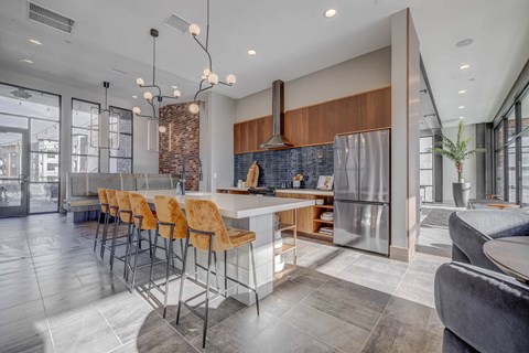 a kitchen with a large island and stainless steel appliances