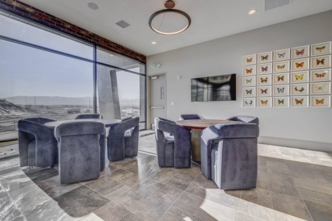 a dining room with a table and chairs and a large window