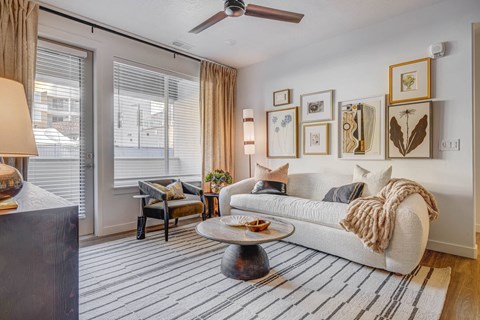 a living room with a couch and a ceiling fan