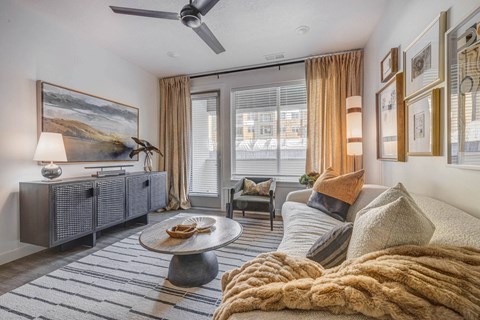 a living room with a couch and a ceiling fan