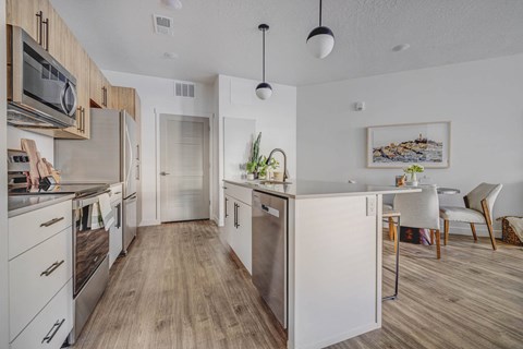 a kitchen with white cabinets and stainless steel appliances