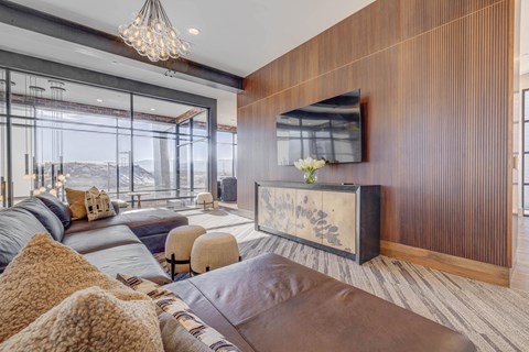 Community room area with a TV and large windows with mountain views