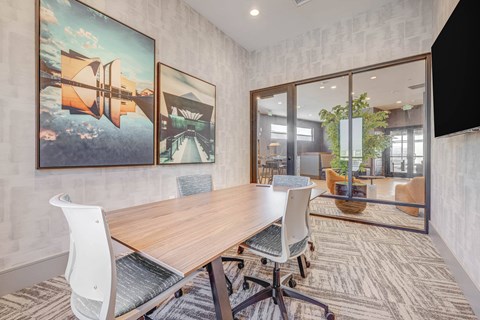 a conference room with a wooden table and chairs