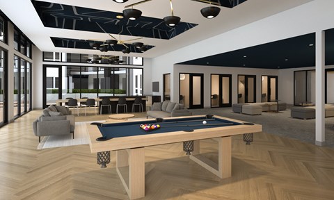 A pool table is in the middle of a room with a ceiling fan.