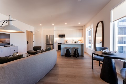 A modern kitchen with a dining table and chairs.