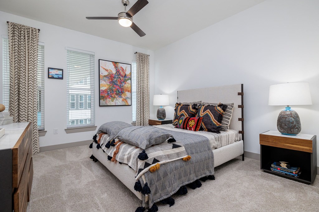 a bedroom with a bed and a ceiling fan