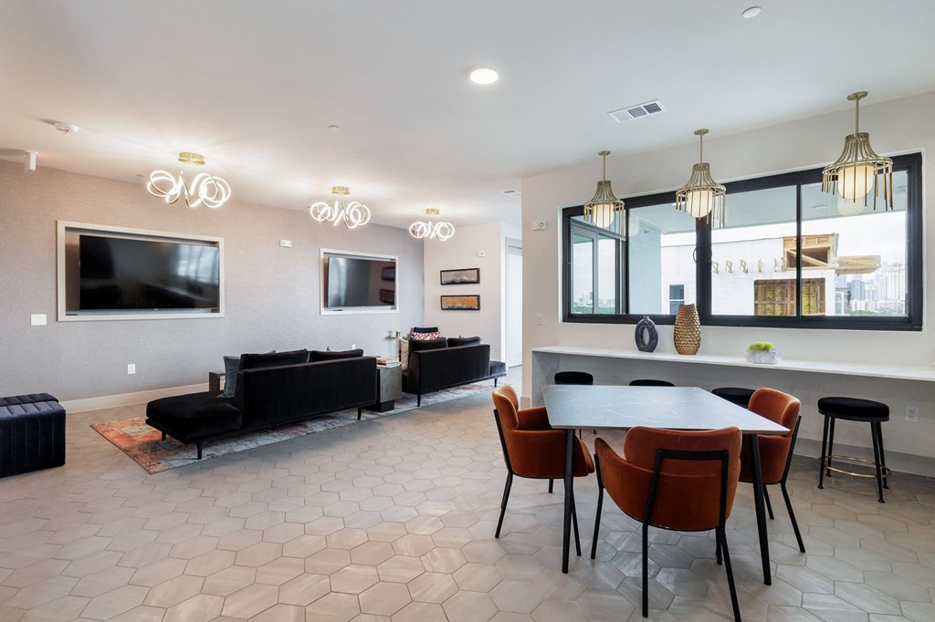a living room with a table and chairs and a television