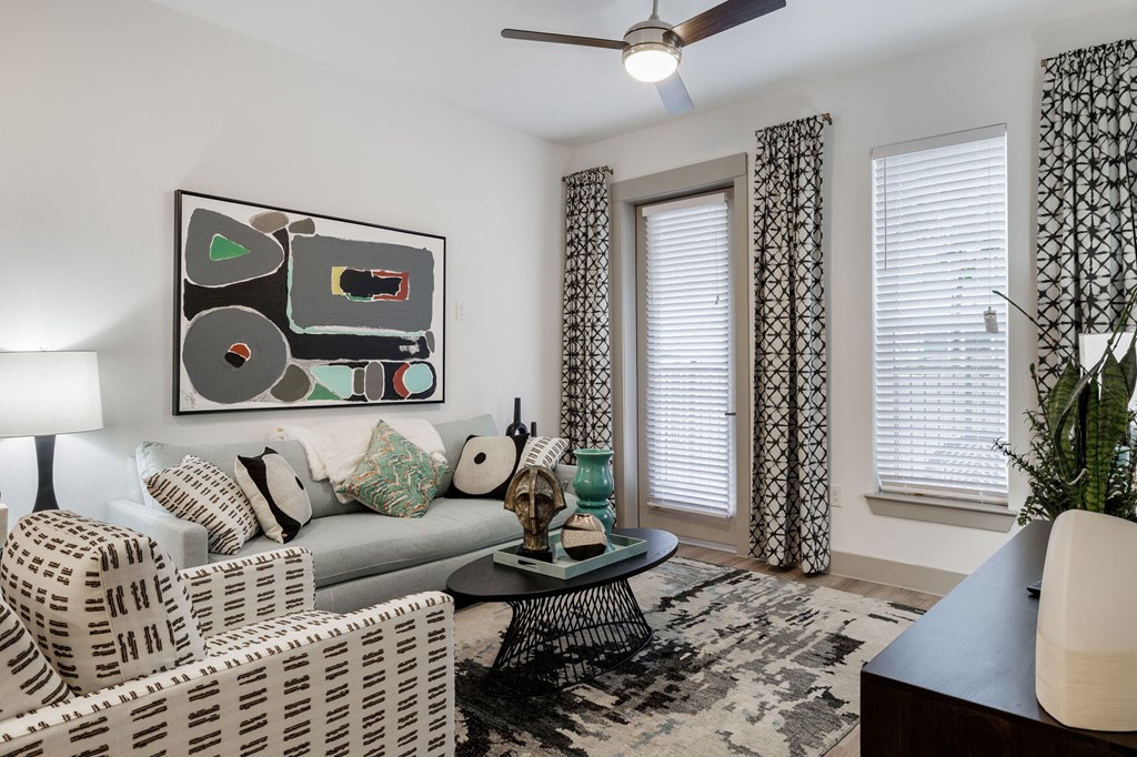 a living room with two chairs and a couch