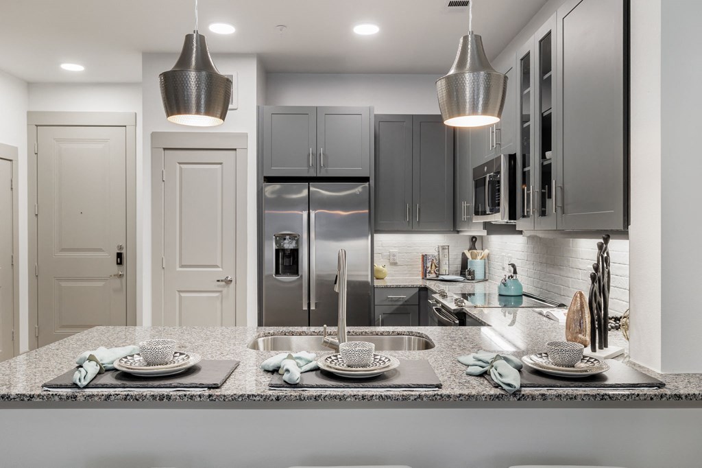 a kitchen with stainless steel appliances and granite counter tops