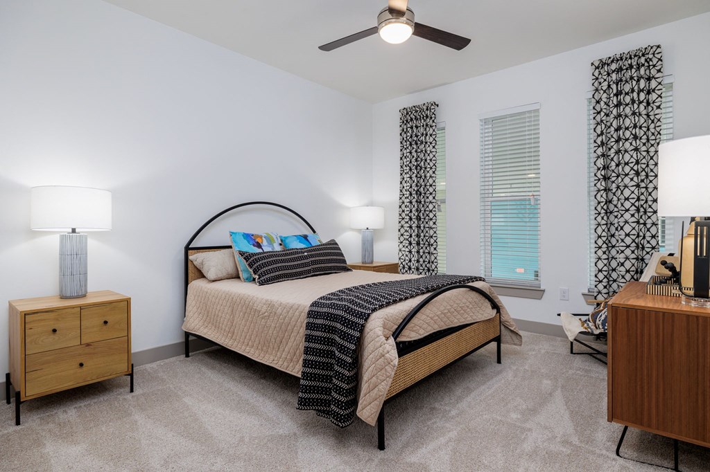 a bedroom with a bed and a ceiling fan