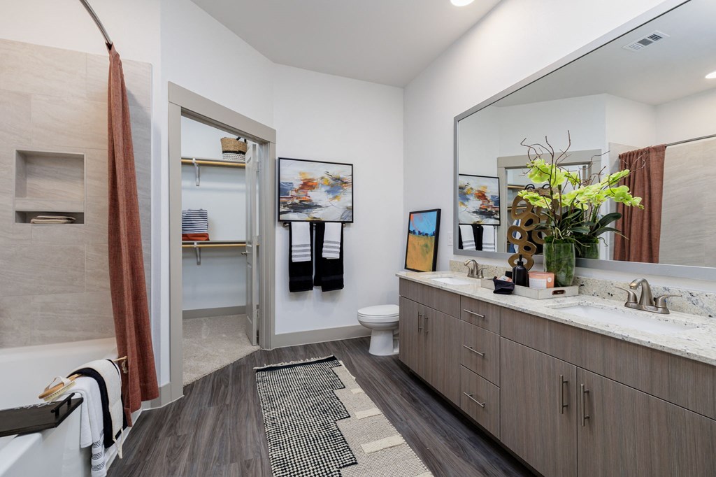 a bathroom with a large mirror and a sink