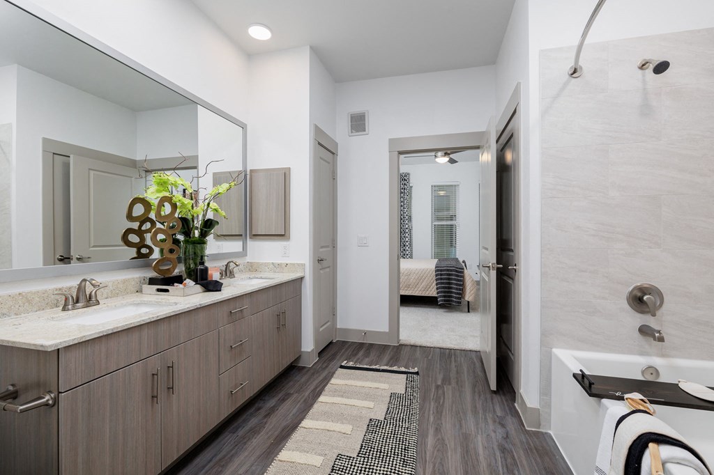 a bathroom with a shower and a sink and a mirror