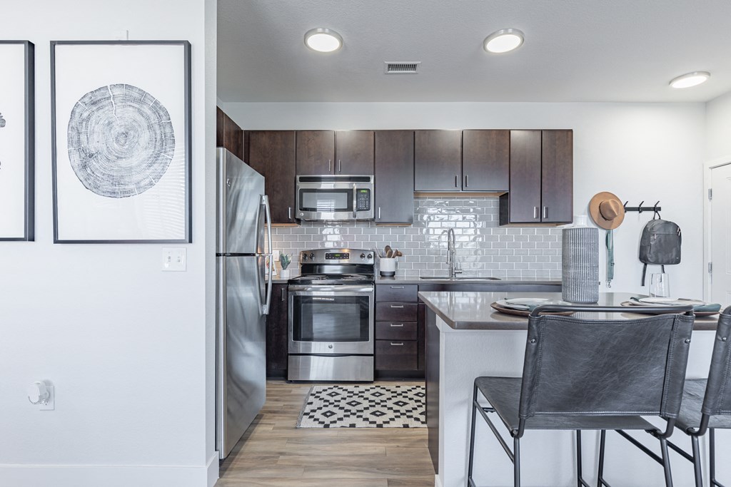 a kitchen with wooden cabinets and stainless steel appliances
