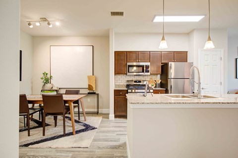 A modern kitchen with a dining table and chairs.
