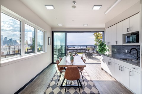 A modern kitchen with a dining table and chairs.