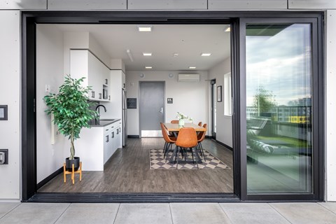 A modern interior of a house with a dining table and chairs.