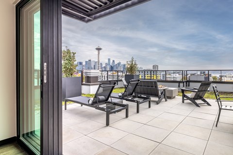 A patio with a view of the city skyline.