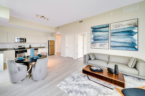 A modern living room with a dining table and a couch.
