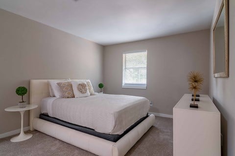 Roswell Creek bedroom with a white bed and a white table