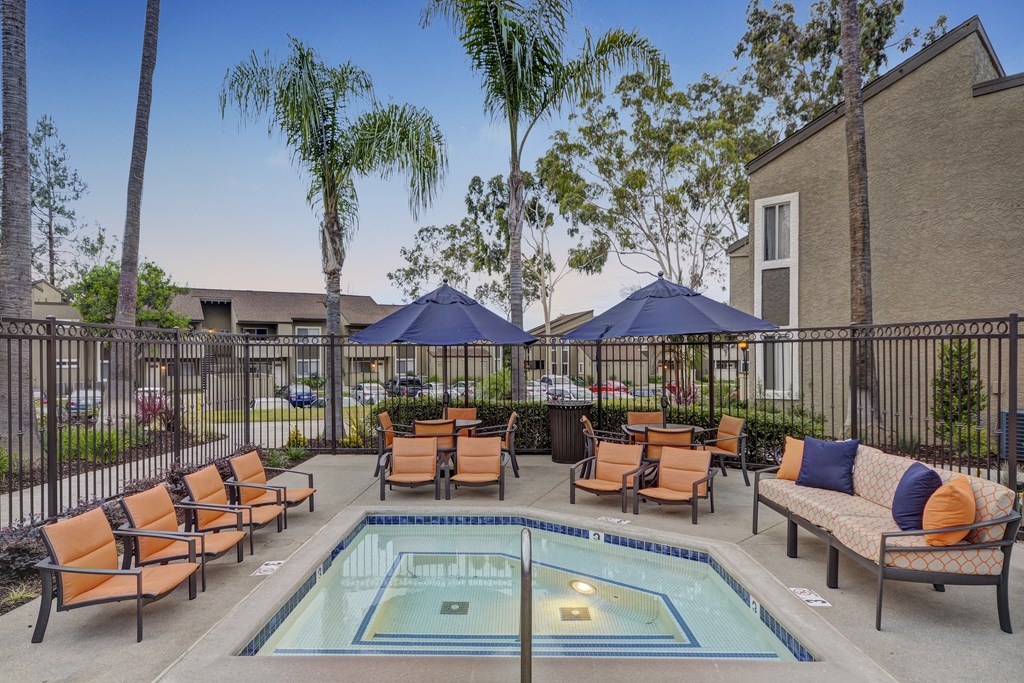 A pool surrounded by chairs and umbrellas.