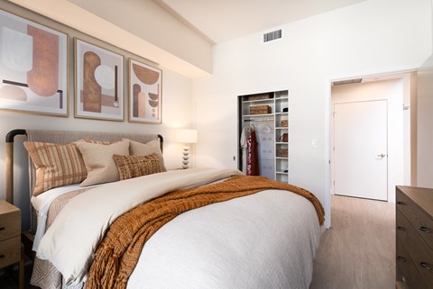 bedroom with a large bed and a closet