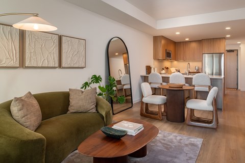 A living room with a green couch and a wooden coffee table.