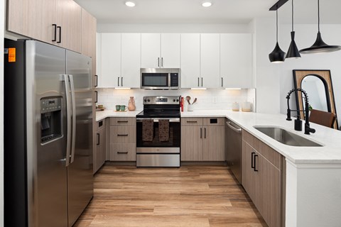 a kitchen with white cabinets and stainless steel appliances