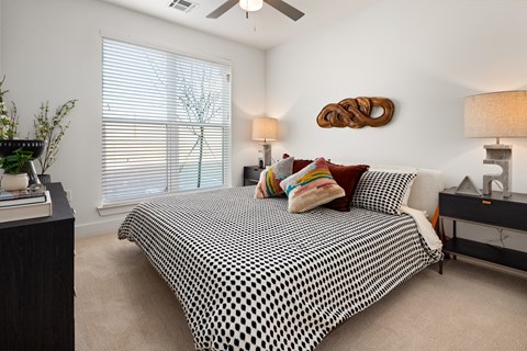 a bedroom with a bed and a ceiling fan