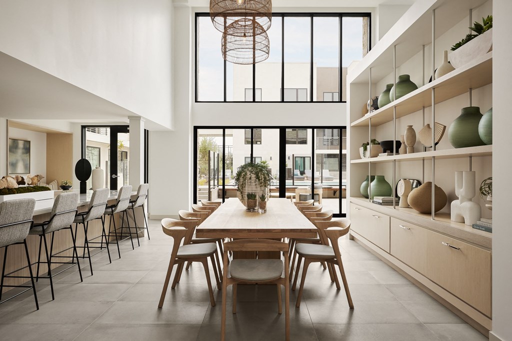 a dining room with a long wooden table and chairs