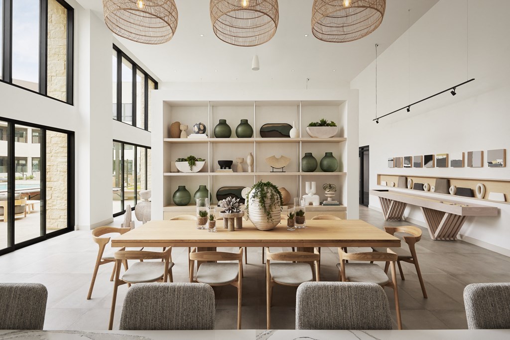 a dining room with a wooden table and chairs