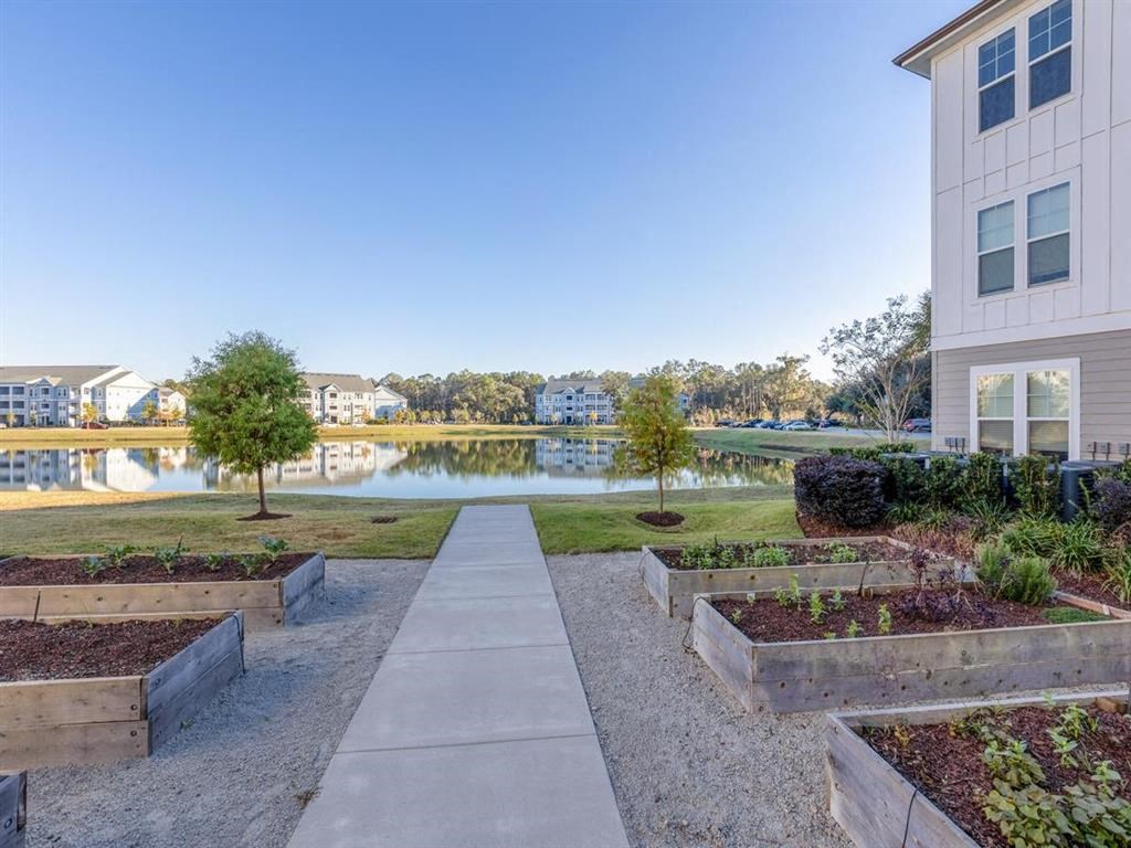 a path leading to a building next to a body of water