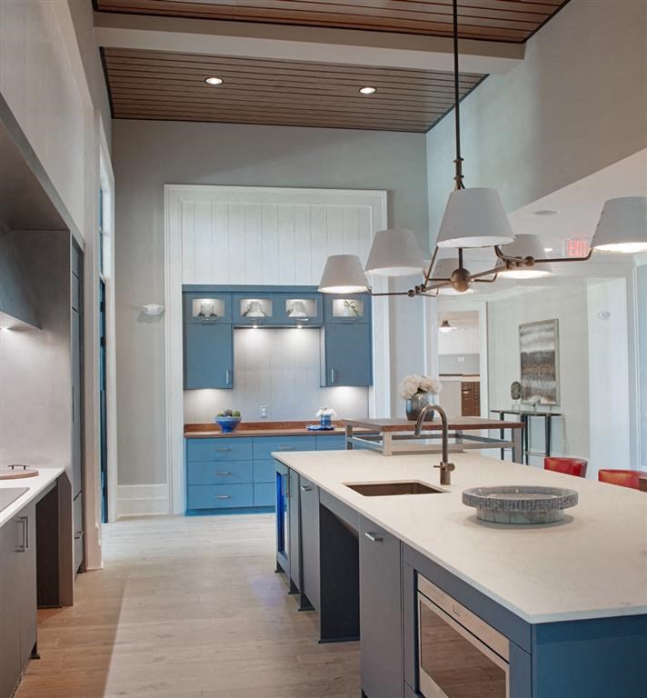 a kitchen with blue cabinets and a white counter top