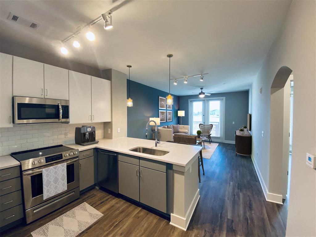 a kitchen and living room with a sink and stove