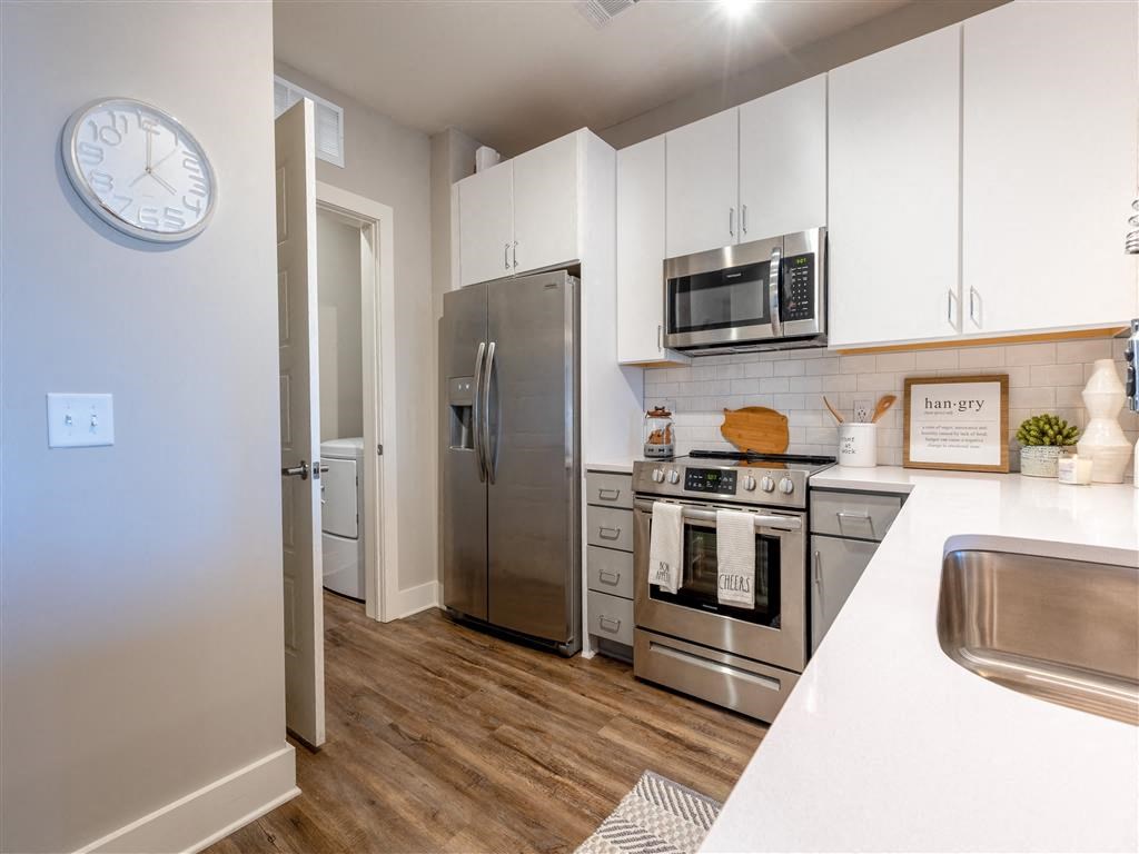 a kitchen with stainless steel appliances and white cabinets