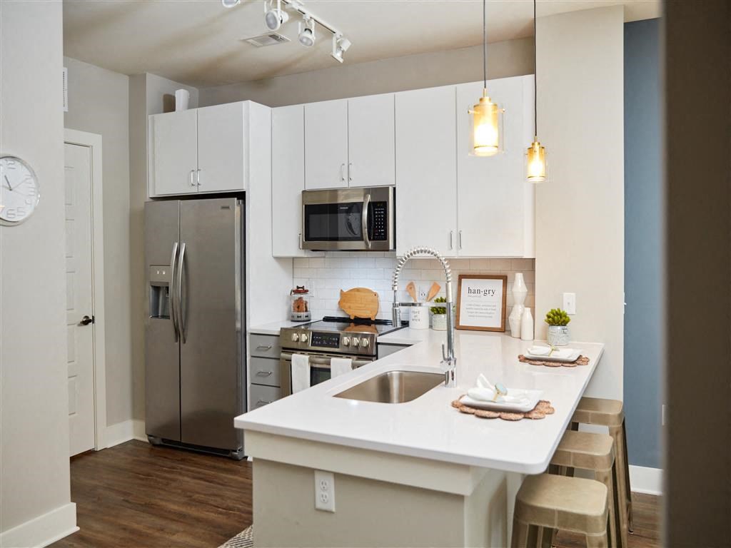 a kitchen with a sink and a refrigerator