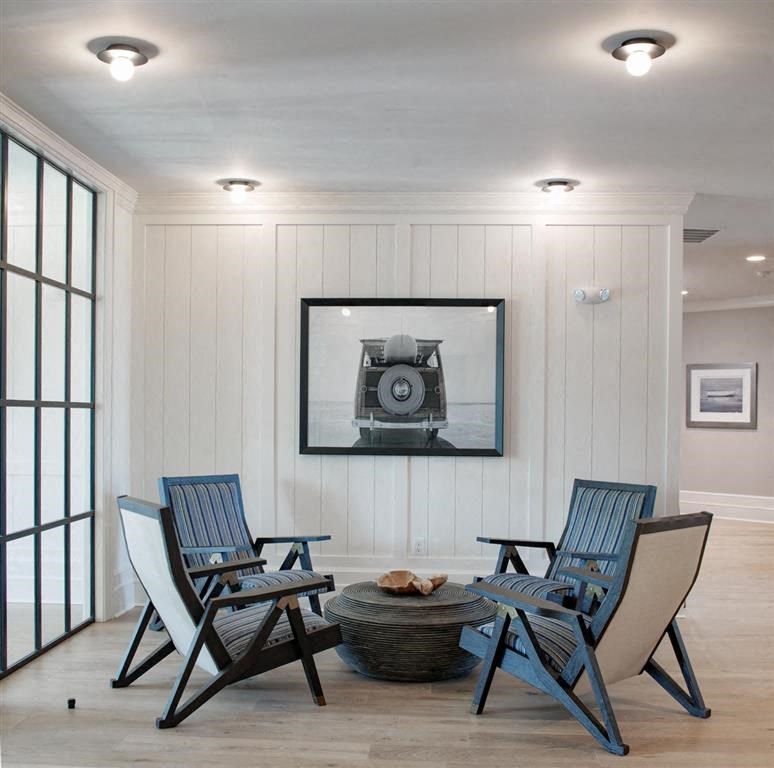 a dining room with blue chairs and a picture of a camera on the wall