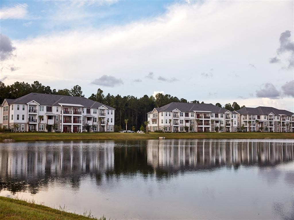 a large lake in front of an apartment building
