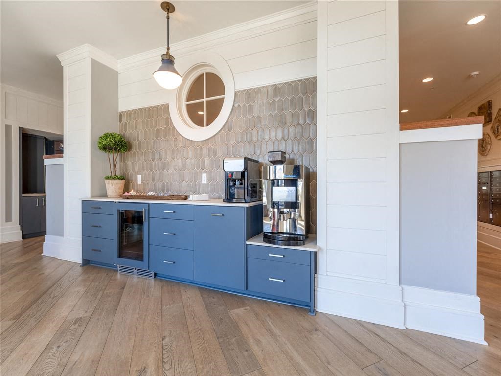 a kitchen with blue cabinets and a coffee machine