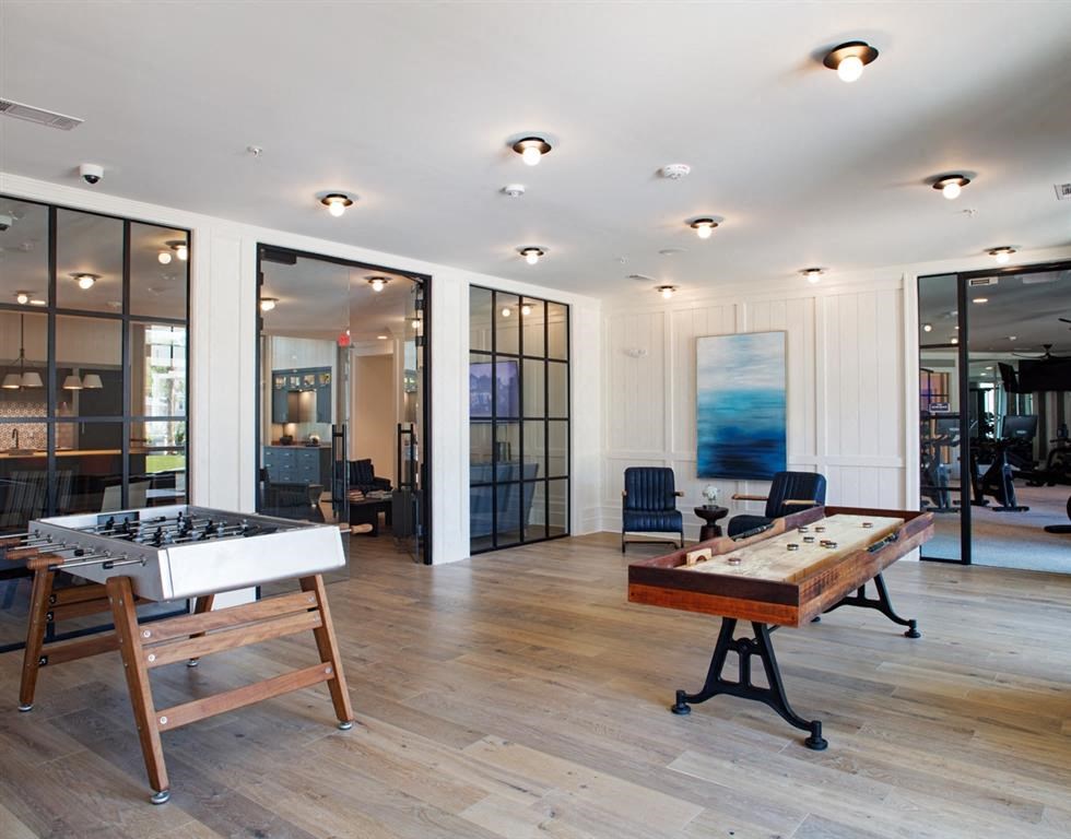 the games room has a foosball table and a shuffleboard