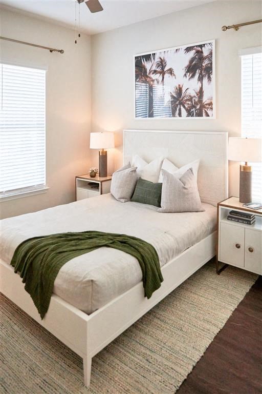 a bedroom with a white bed and a green blanket