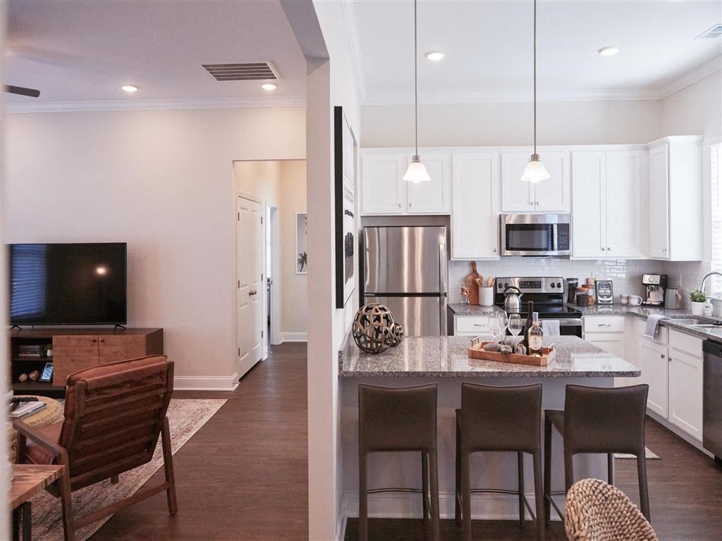 a kitchen and living room with a table and chairs