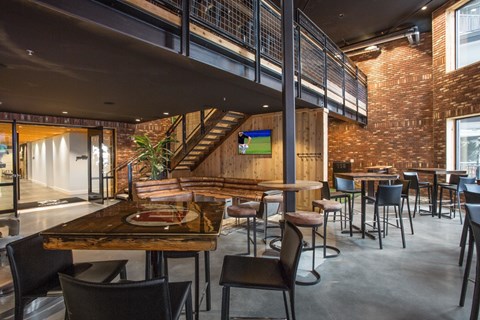 A modern dining area with a wooden table and chairs.