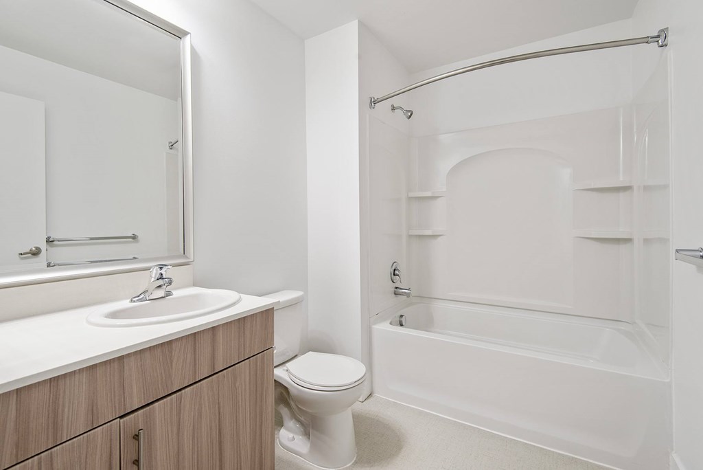 A white bathroom with a sink, toilet, and bathtub.