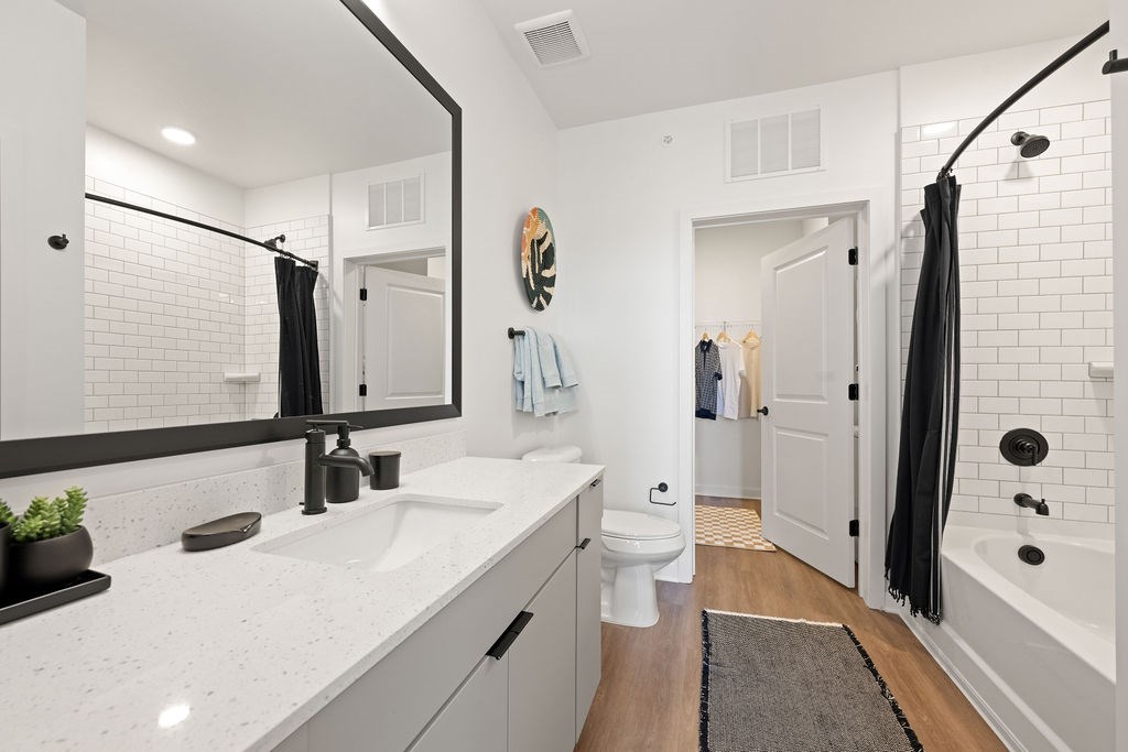 A bathroom with a white sink and a mirror.