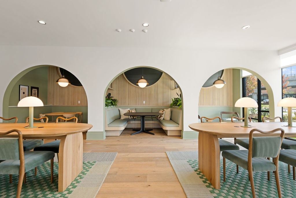 A modern dining room with wooden tables and chairs.