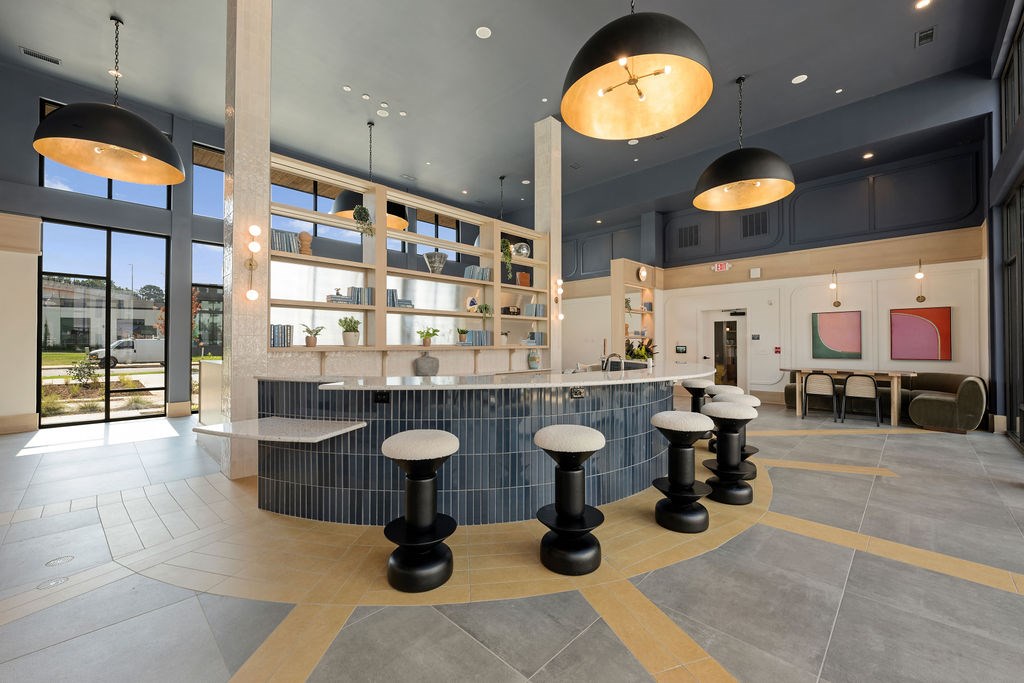 A modern cafe with a bar and stools.