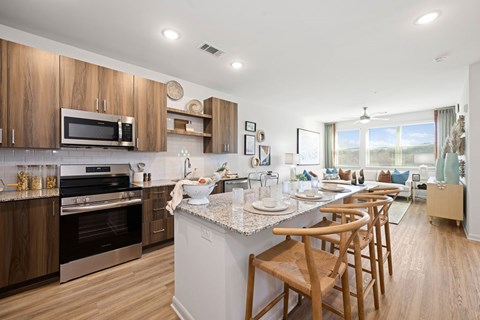 A modern kitchen with wooden cabinets and stainless steel appliances.