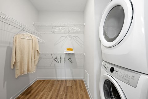 A small laundry room with a washer and dryer.