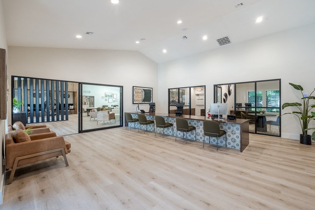 a living room with a table and chairs in the middle of it