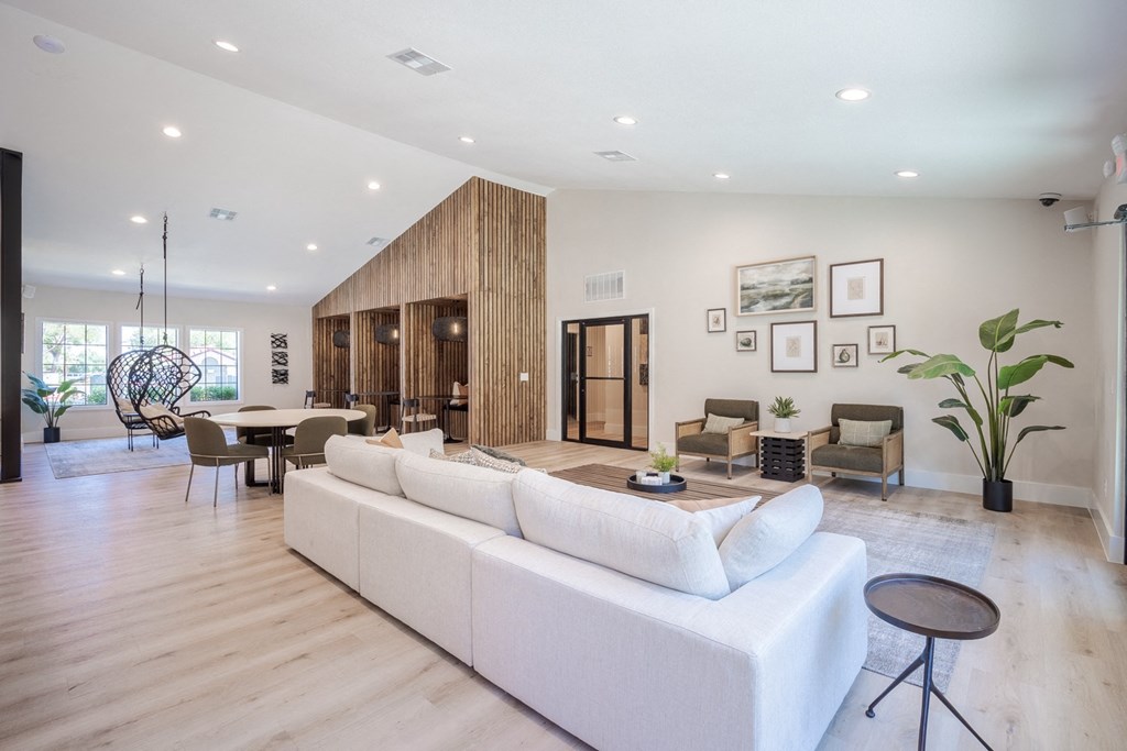 a living room with a white couch and a table and chairs